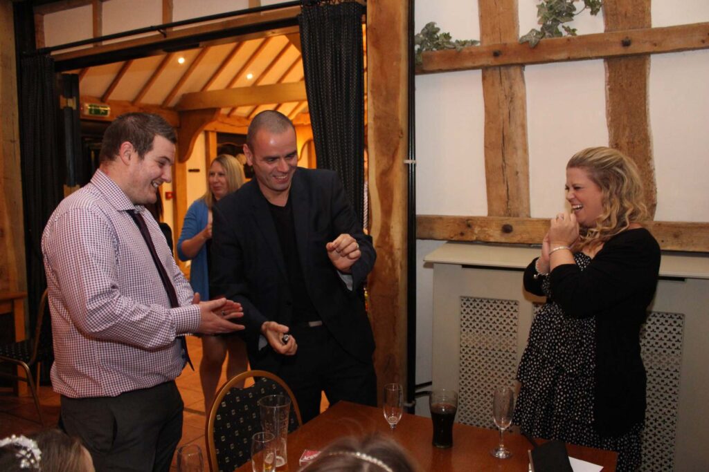 Andy Magicman performing close-up card magic for guests, showcasing professional magician services for weddings, parties, and corporate events across the UK.