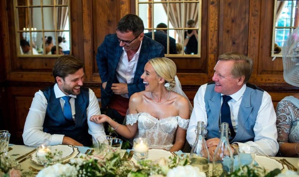 Bride and groom laughing as wedding magician Andy Magicman performs close-up magic during the wedding breakfast at an Essex wedding.