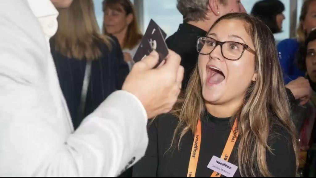 Corporate magician performing close-up magic at a corporate event