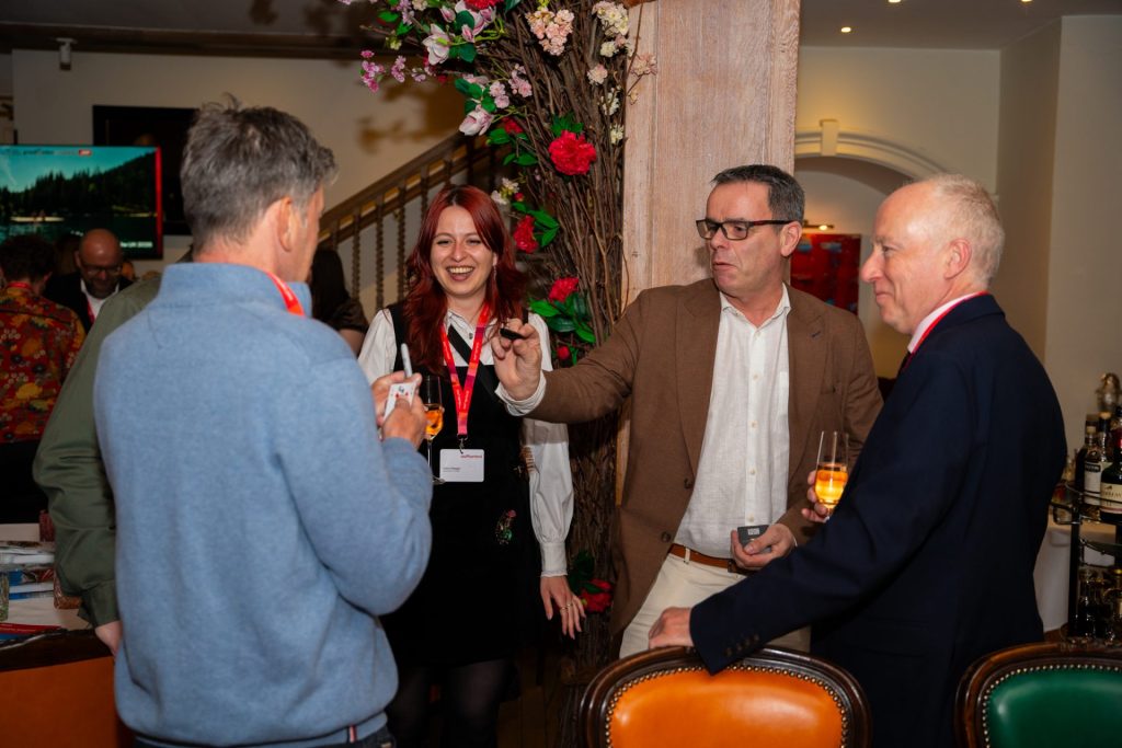Close-up magician entertaining guests at a corporate drinks reception