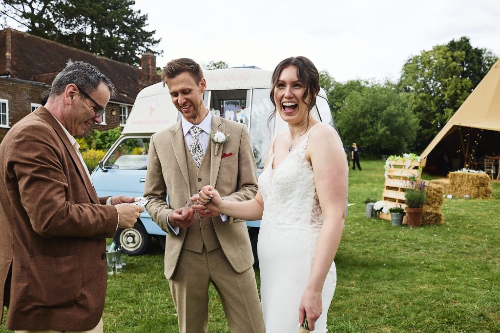 Magician entertaining bride and groom at wedding reception